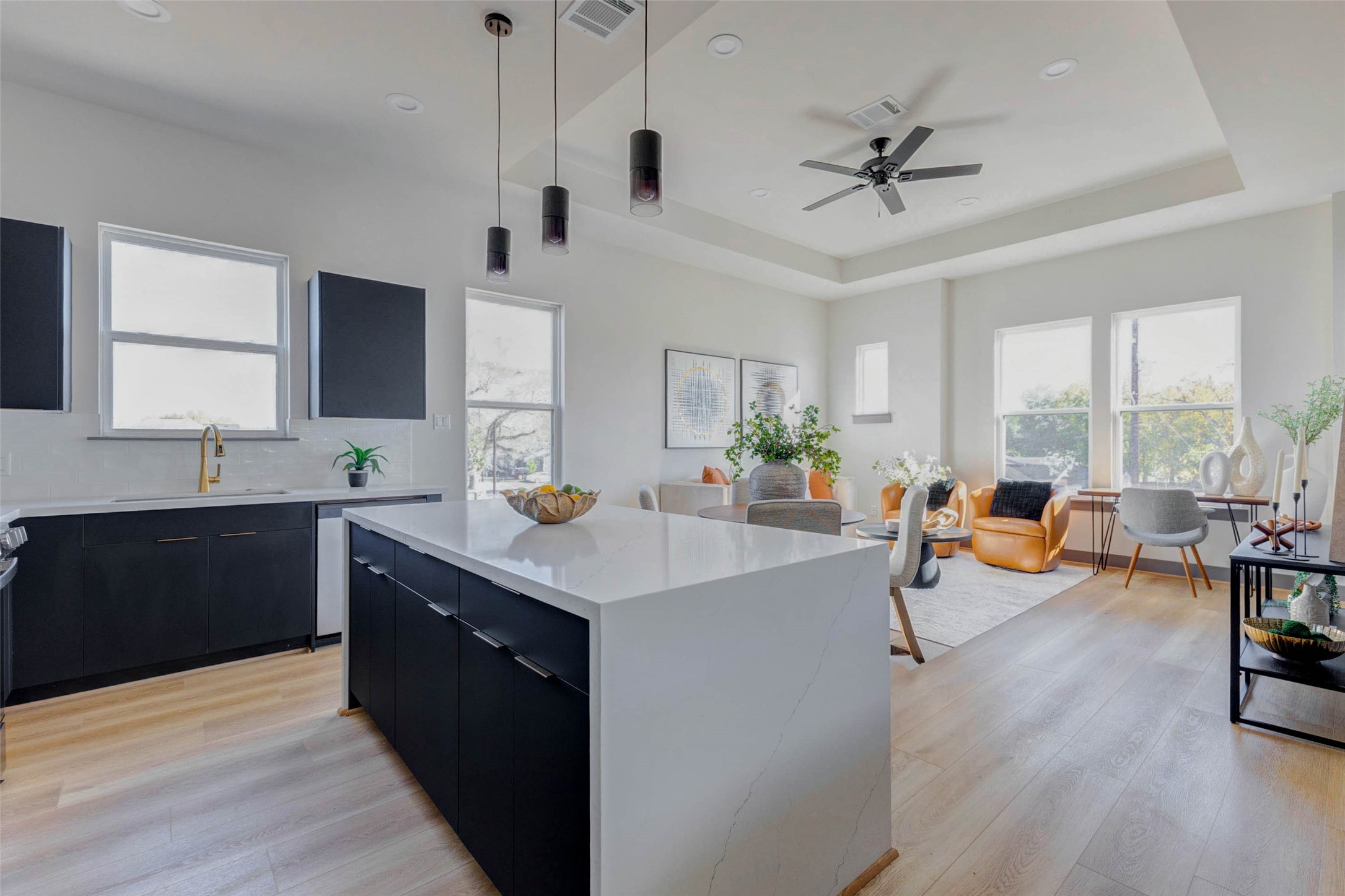 4803 Paula Street Houston, TX 77033 - Photo 5 of 28 Bright and modern open-concept kitchen and well-lit living area with plenty of windows, light luxury vinyl plank flooring, and contemporary finishes, creating a welcoming and airy atmosphere.