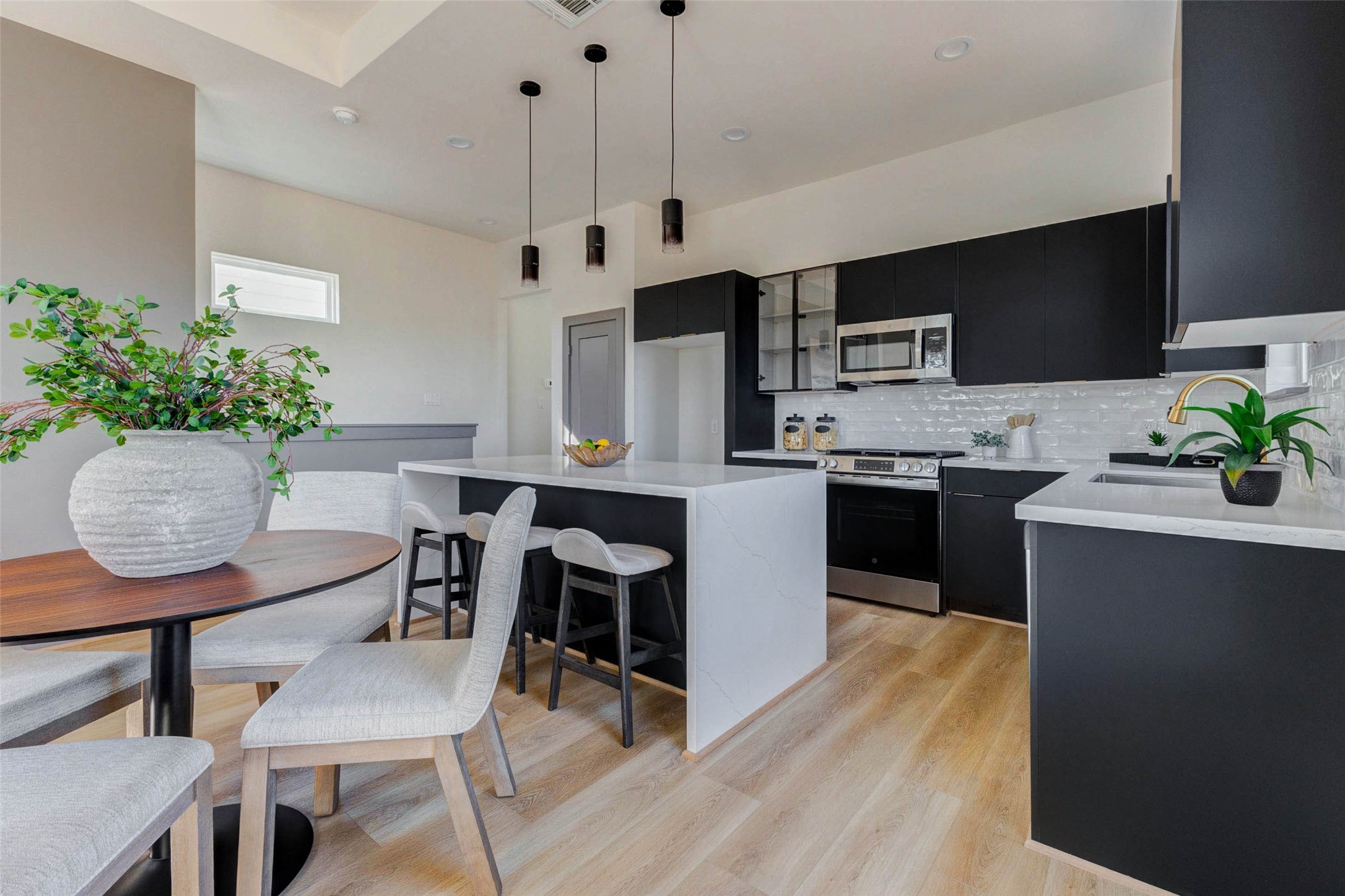 4803 Paula Street Houston, TX 77033 - Photo 6 of 28 The European style cabinets with gold hardware and soft closing doors and drawers elevate the style in this chef's kitchen.