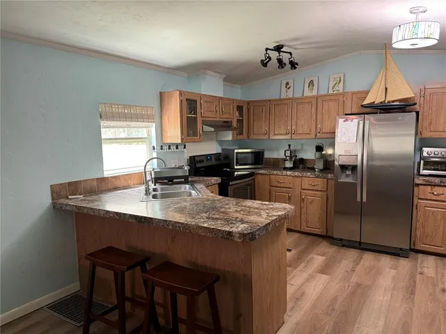 a large kitchen with a table and chairs