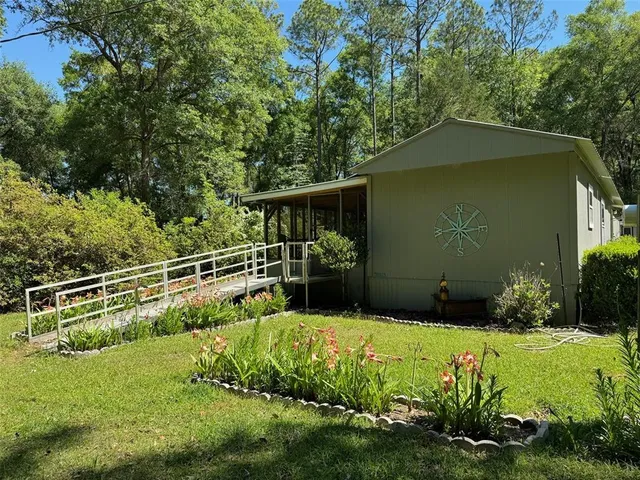 a kitchen with stainless steel appliances granite countertop a sink dishwasher a stove a refrigerator with a dining table and chairs