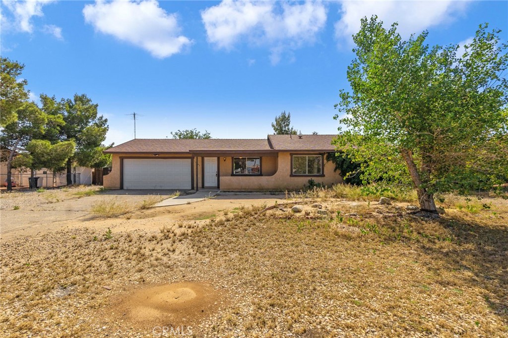 10793 Jamul Road Apple Valley, CA 92308 - Photo 1 of 1 a front view of a house with a garden