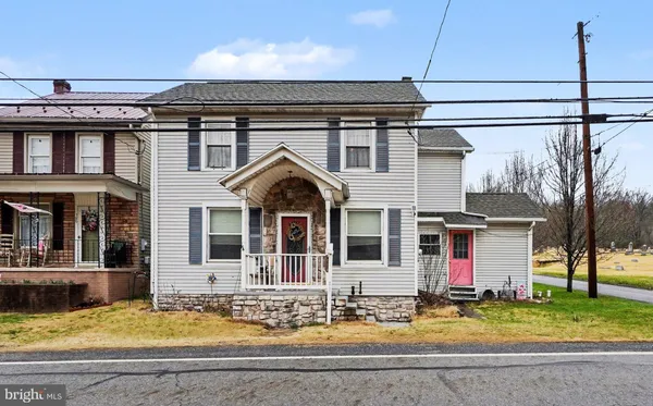 a view of a house with swimming pool and porch with furniture
