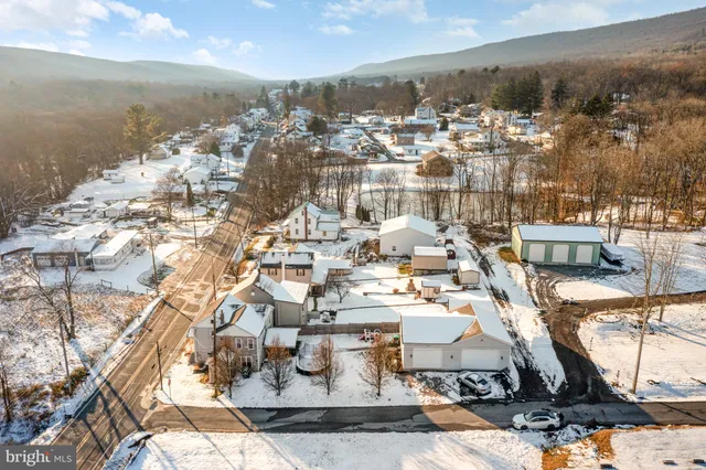 an aerial view of a house with a ocean view