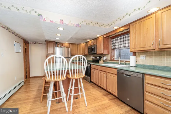 a stove top oven sitting inside of a kitchen