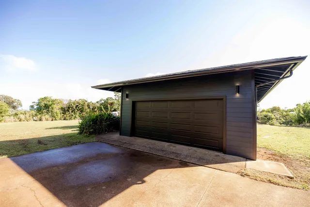 a backyard of a house with a yard and garage