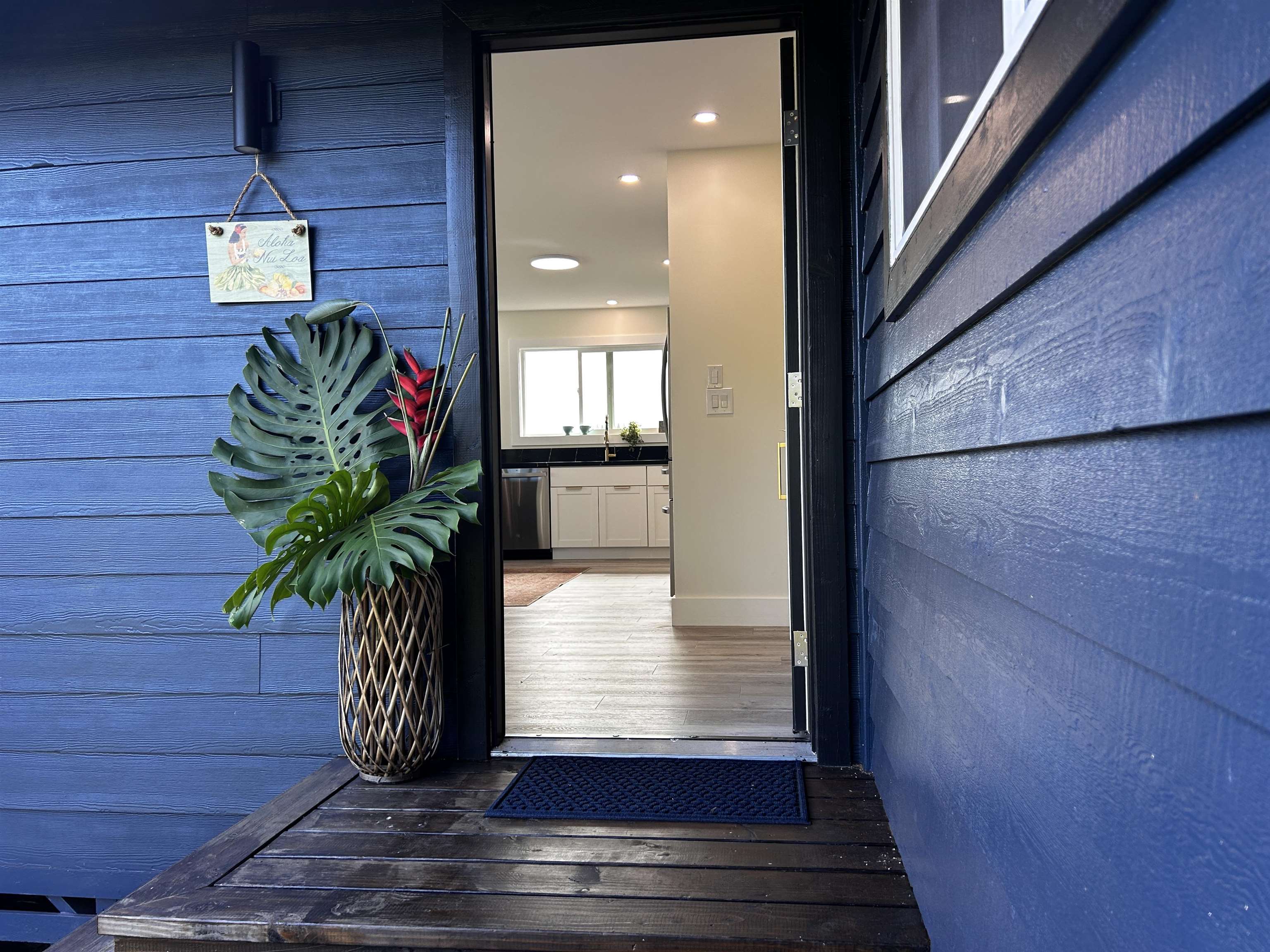 1139 Kauhikoa Road, Unit A Haiku, HI 96708 - Photo 18 of 42 a potted plant sitting in front of a door