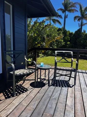 a view of a chairs and table in the balcony