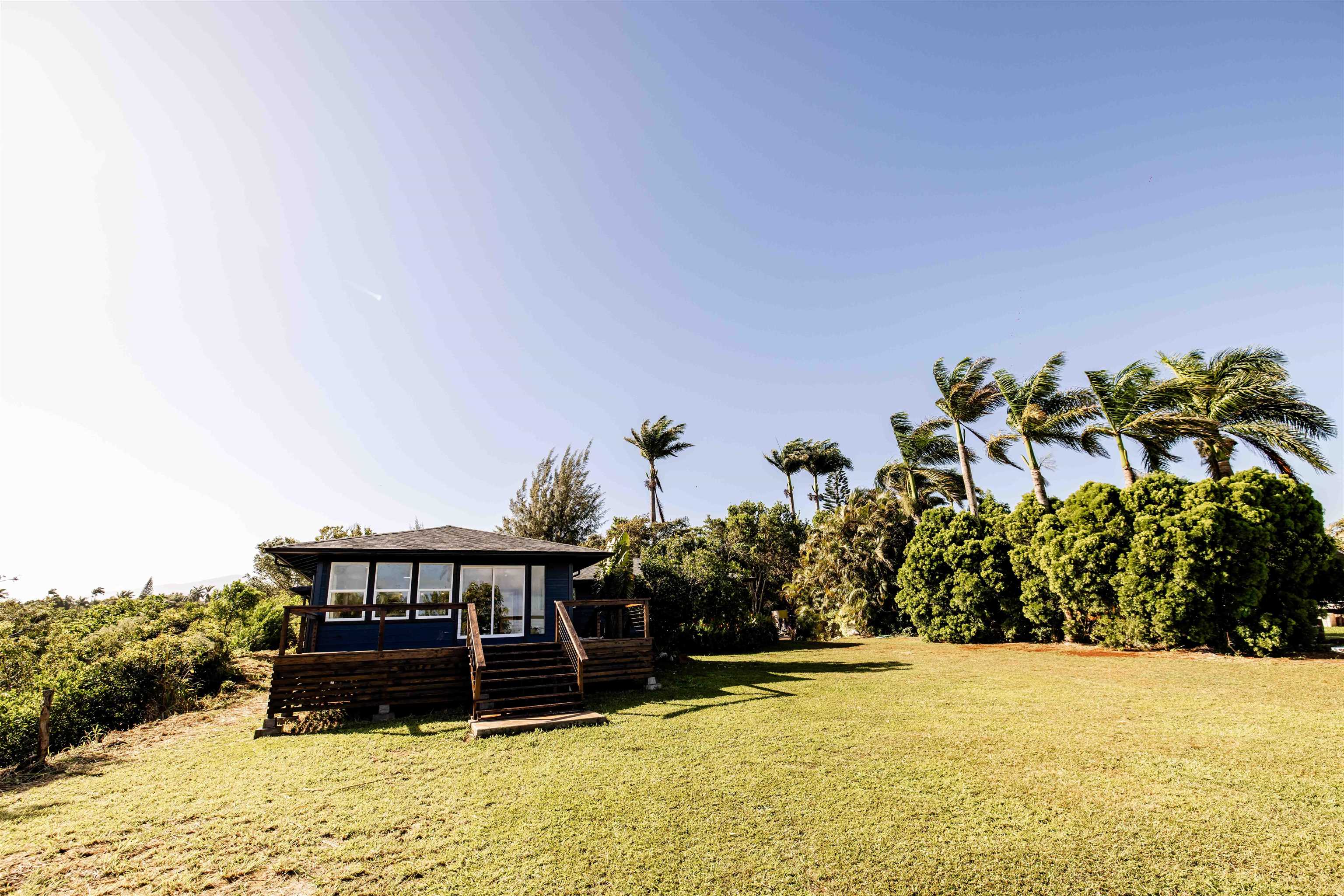1139 Kauhikoa Road, Unit A Haiku, HI 96708 - Photo 21 of 42 a front view of a house with a yard