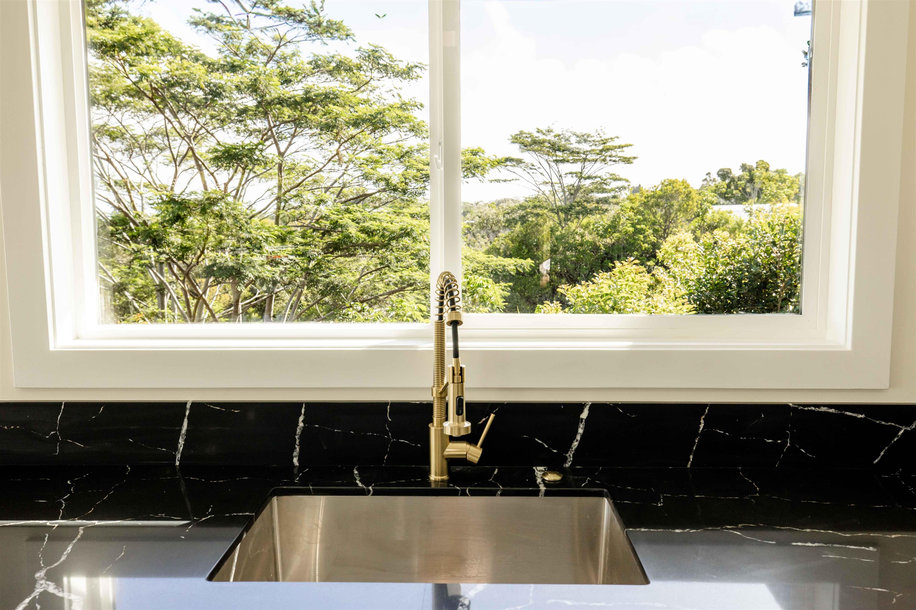 1139 Kauhikoa Road, Unit A Haiku, HI 96708 - Photo 22 of 42 a bathroom with a sink and a window