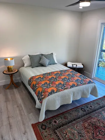 a bedroom with a bed lamp and a fireplace