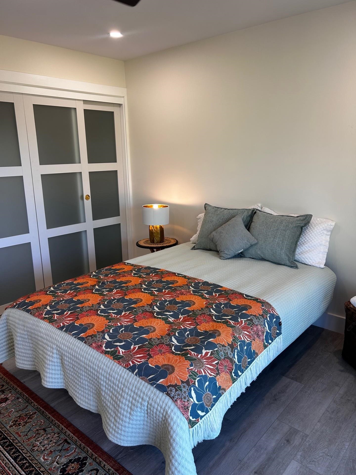 1139 Kauhikoa Road, Unit A Haiku, HI 96708 - Photo 29 of 42 a bedroom with a bed and wooden floor