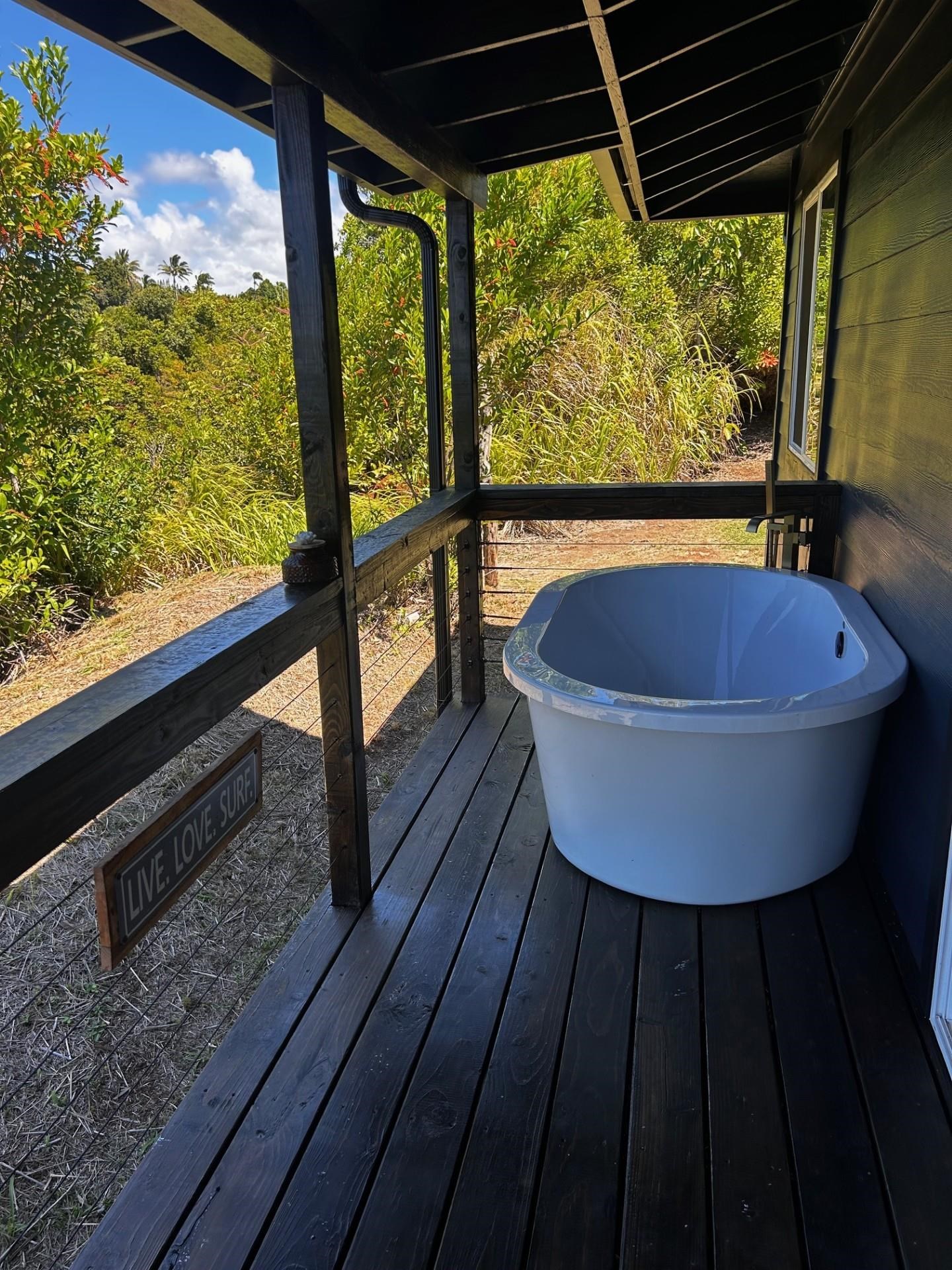 1139 Kauhikoa Road, Unit A Haiku, HI 96708 - Photo 31 of 42 a table and chairs sitting in a back yard of a building