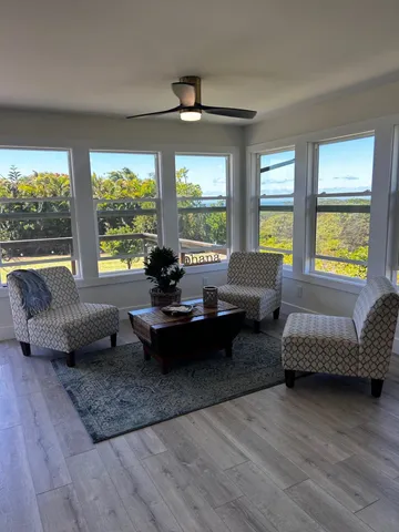 a living room with furniture and a large window