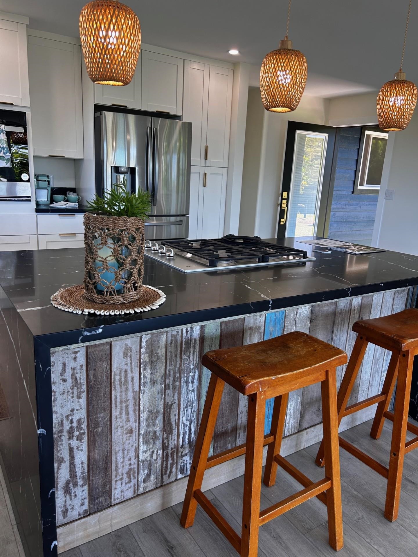 1139 Kauhikoa Road, Unit A Haiku, HI 96708 - Photo 4 of 42 a kitchen with stainless steel appliances granite countertop a stove a sink and a refrigerator