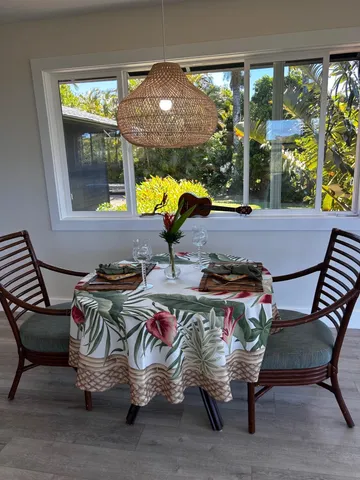 a view of a patio with table and chairs with wooden floor and fence