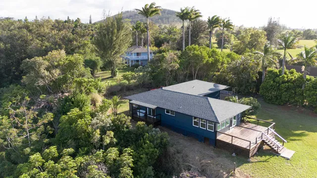 an aerial view of a house with a yard basket ball court and outdoor seating