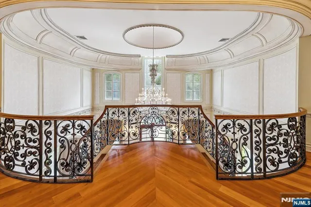 a view of a room with wooden floor and windows