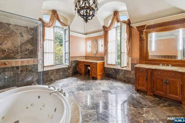 a bathroom with a tub sink and mirror