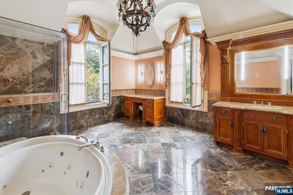47 Fox Hedge Road Saddle River, NJ 07458 - Photo 13 of 22 a bathroom with a tub sink and mirror