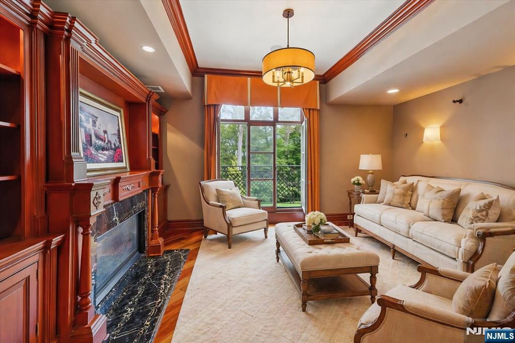 47 Fox Hedge Road Saddle River, NJ 07458 - Photo 14 of 24 a living room with furniture a flat screen tv and a large window