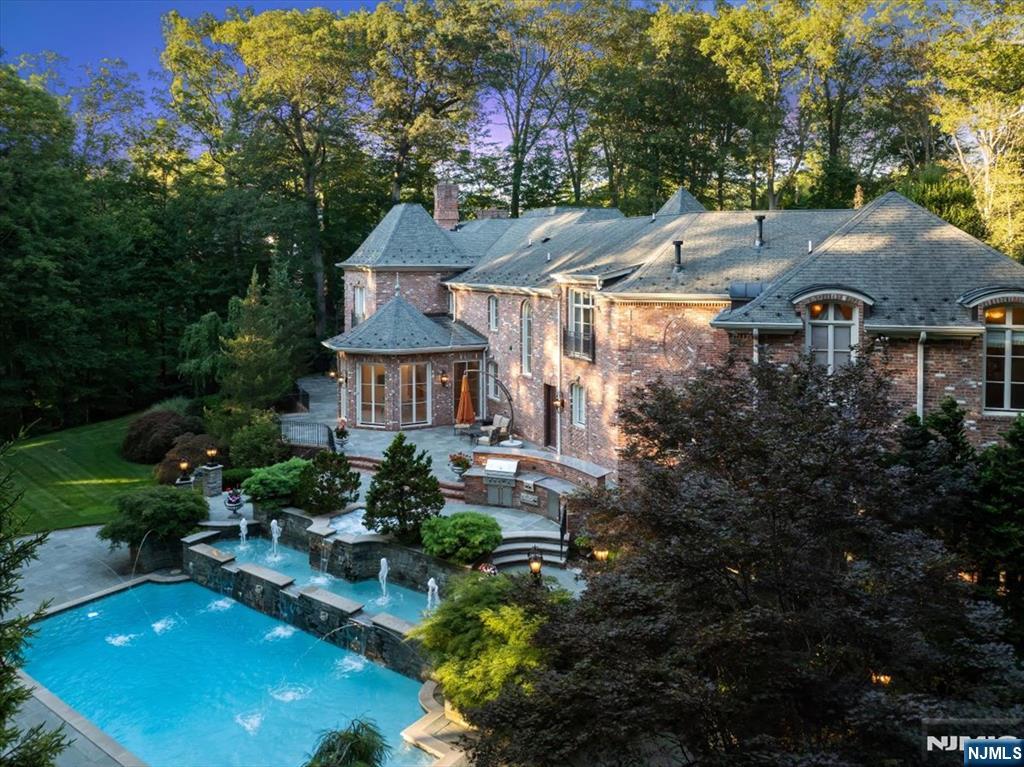 47 Fox Hedge Road Saddle River, NJ 07458 - Photo 2 of 22 a aerial view of a house with swimming pool garden and mountain view in back