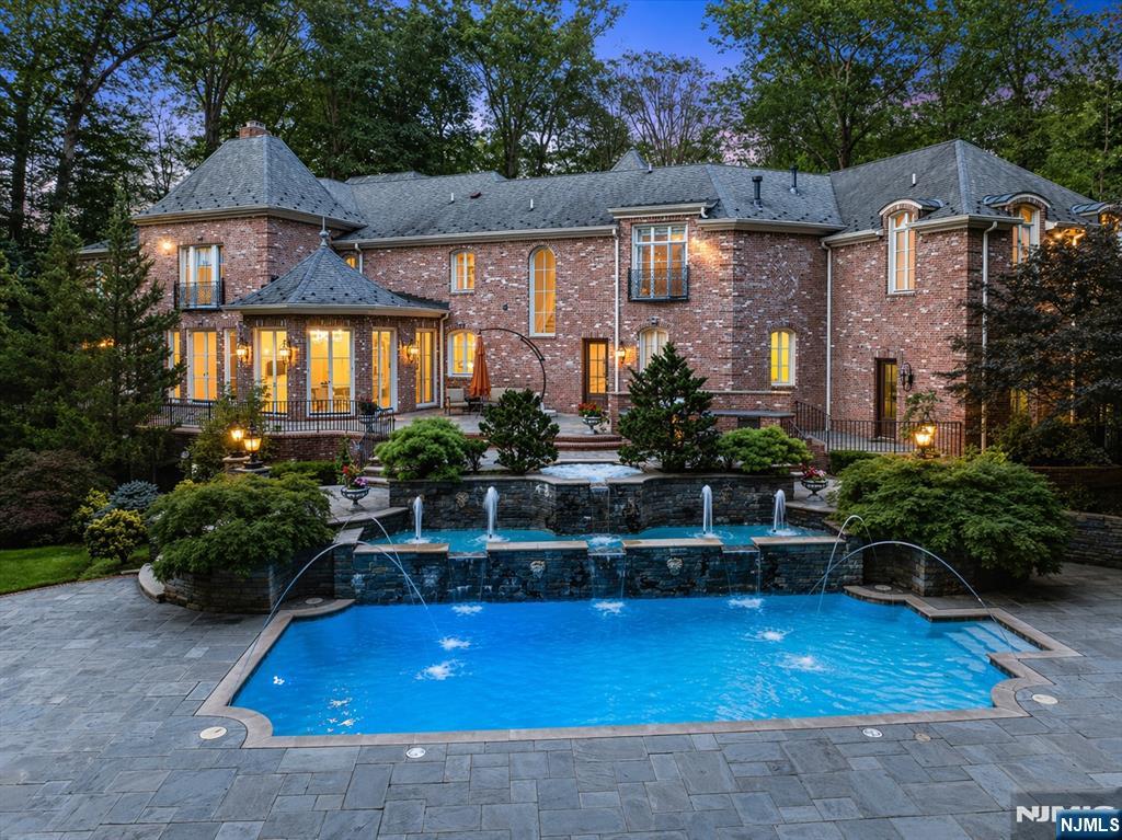 47 Fox Hedge Road Saddle River, NJ 07458 - Photo 2 of 24 a front view of house with yard and trees in the background