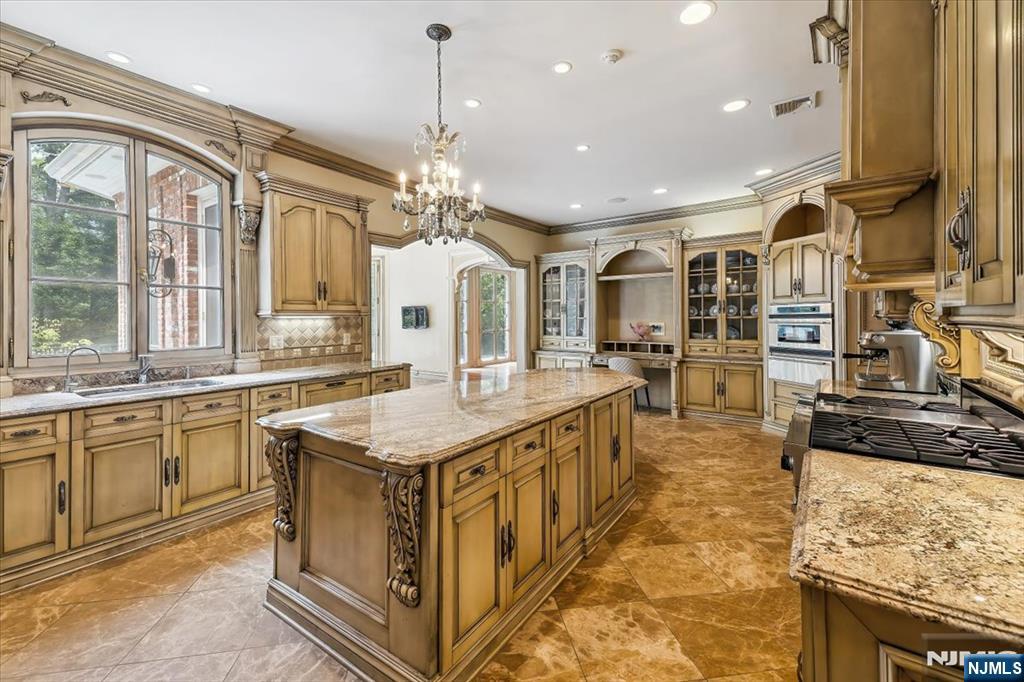 47 Fox Hedge Road Saddle River, NJ 07458 - Photo 8 of 24 a kitchen with stainless steel appliances granite countertop a sink and a stove