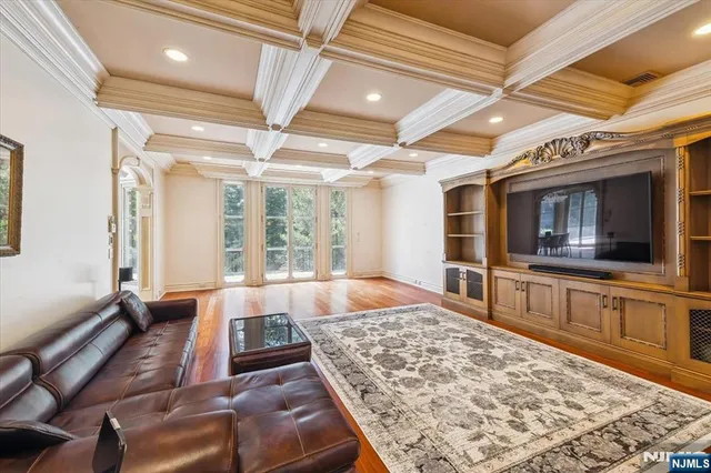 a living room with a large bed and a flat screen tv