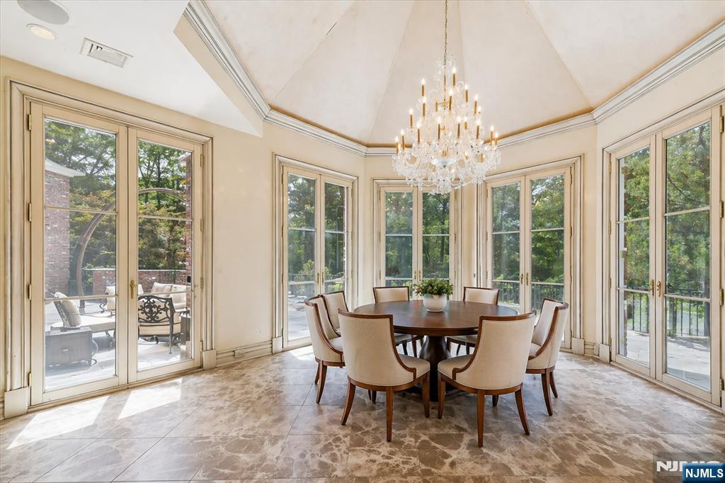 47 Fox Hedge Road Saddle River, NJ 07458 - Photo 9 of 24 a view of a dining room with furniture large windows and wooden floor