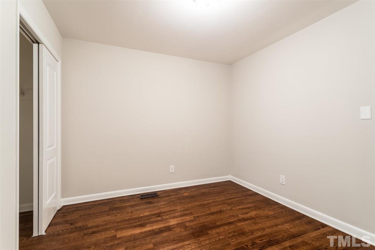 508 Cooper Road Raleigh, NC 27610 - Photo 14 of 25 a view of an empty room with wooden floor
