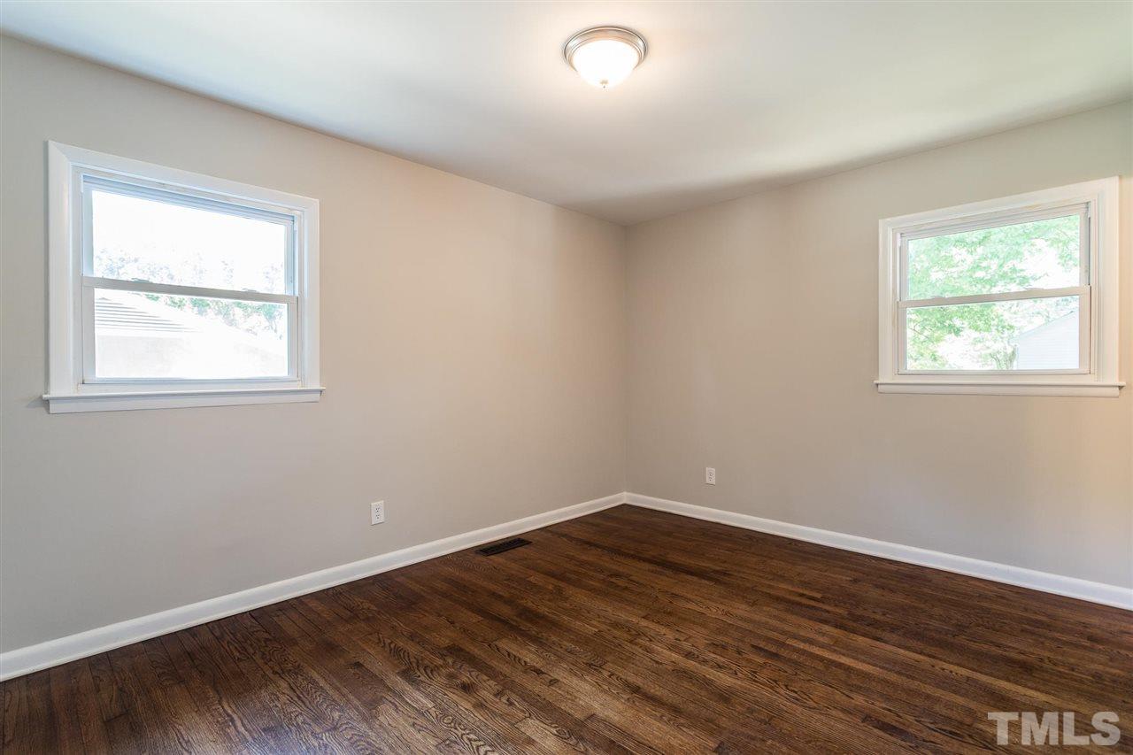 508 Cooper Road Raleigh, NC 27610 - Photo 17 of 25 an empty room with wooden floor and windows