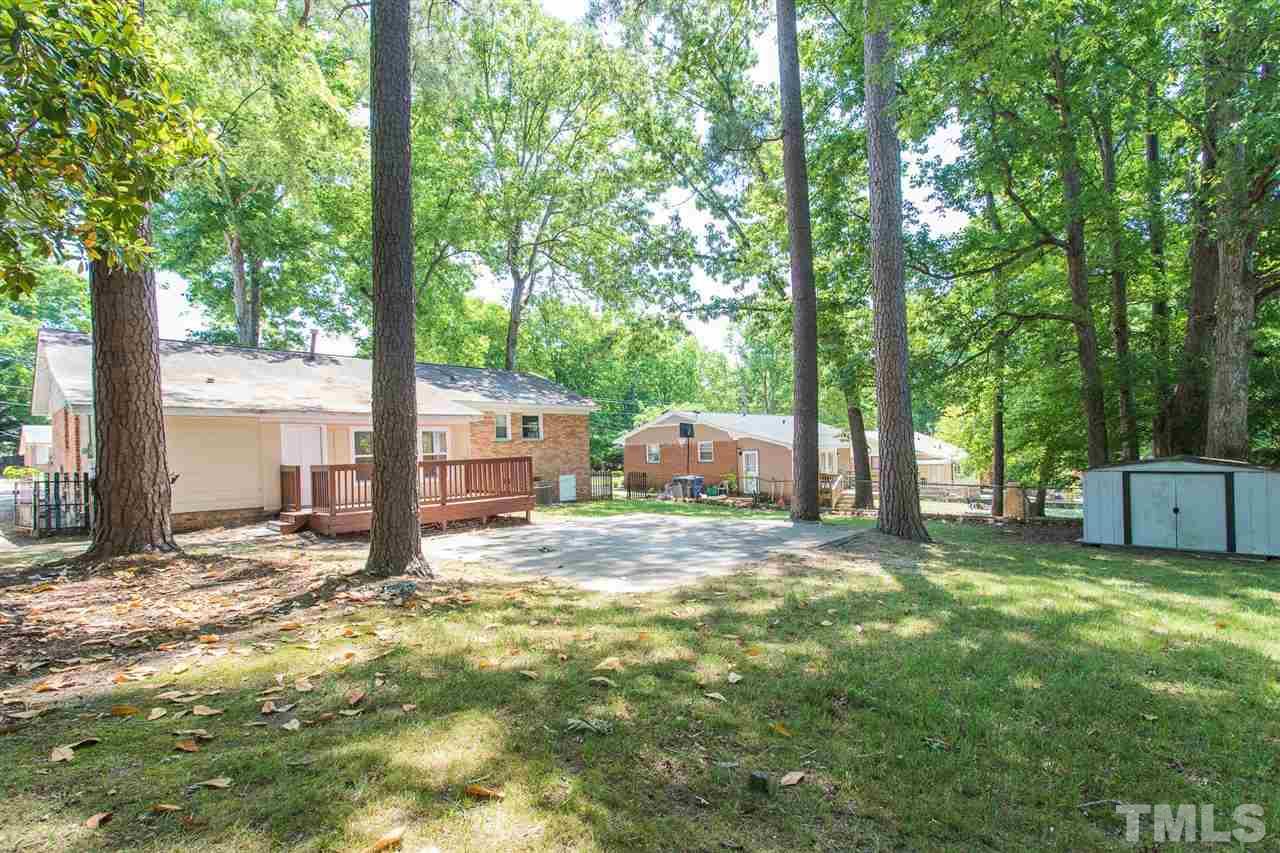 508 Cooper Road Raleigh, NC 27610 - Photo 21 of 25 a view of a backyard with large trees and a large tree