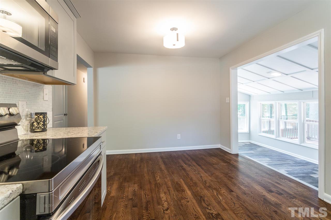 508 Cooper Road Raleigh, NC 27610 - Photo 4 of 25 a view of kitchen island with wooden floor and electronic appliances
