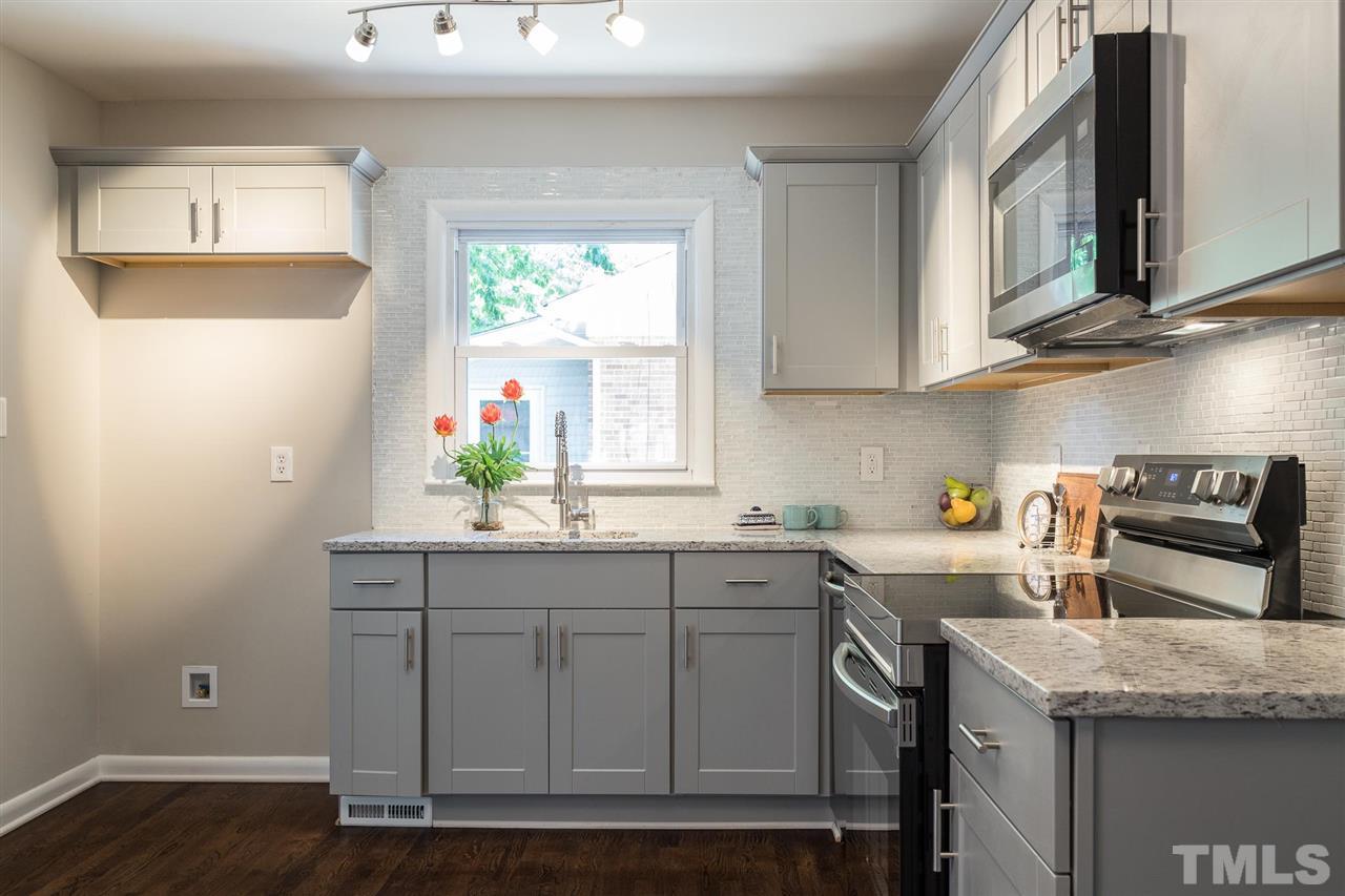 508 Cooper Road Raleigh, NC 27610 - Photo 8 of 25 a kitchen with stainless steel appliances granite countertop a sink and cabinets