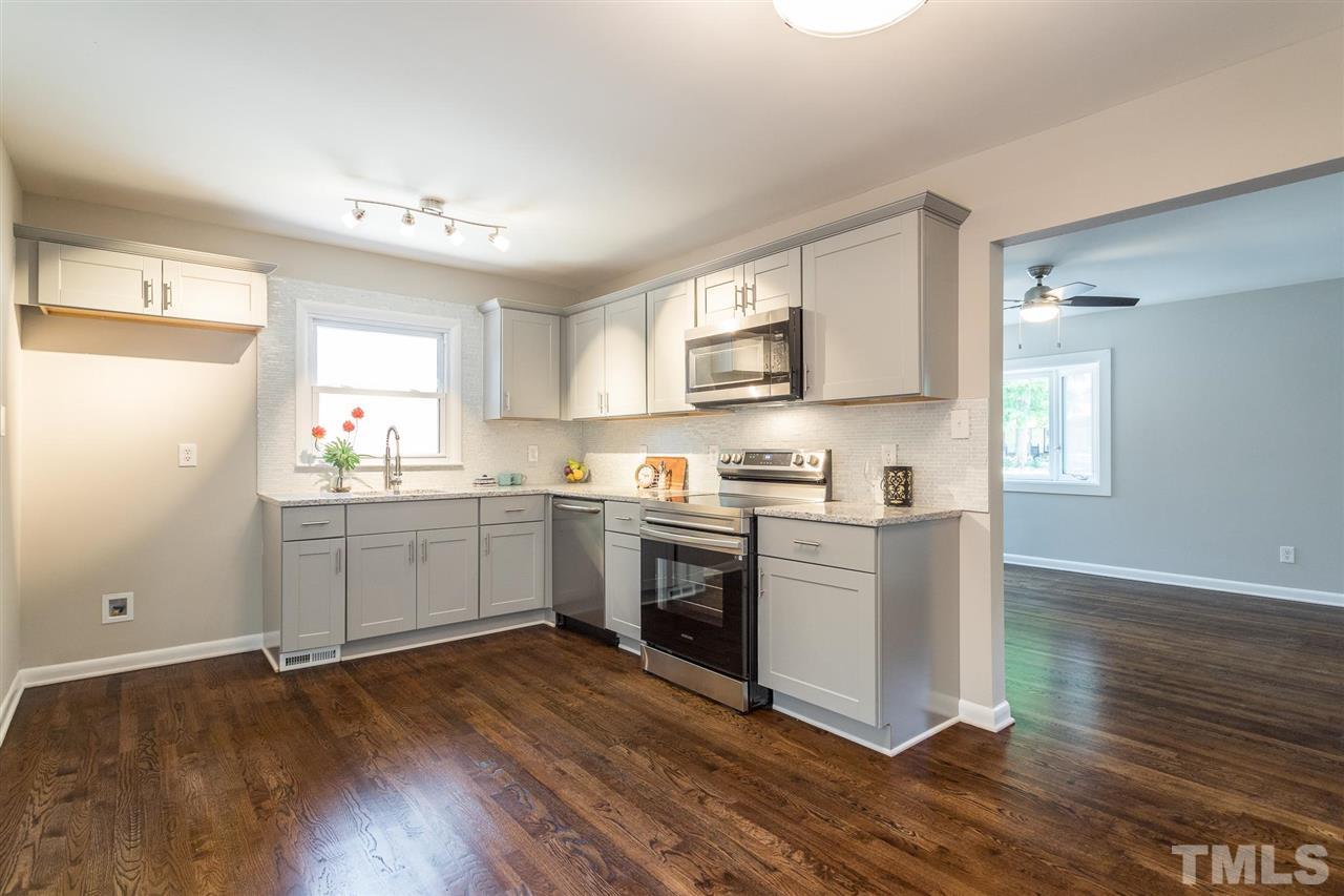 508 Cooper Road Raleigh, NC 27610 - Photo 9 of 25 a kitchen with a refrigerator stove top oven and sink