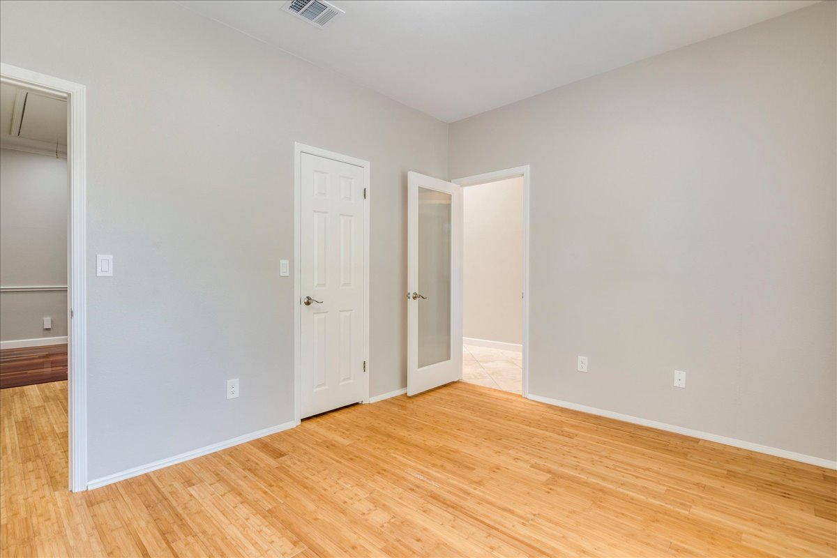 6530 Needham Lane Austin, TX 78739 - Photo 20 of 29 Natural wood flooring complements this adaptable room, ideal for an office or additional living area.