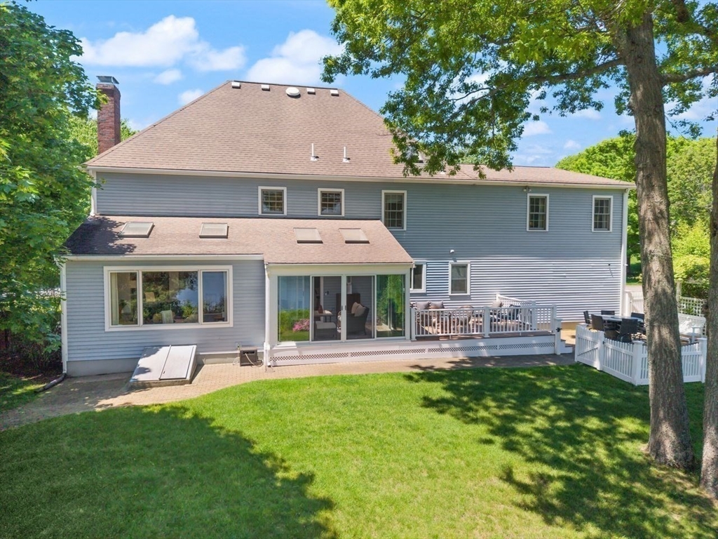 9 Bragg Road Foxboro, MA 02035 - Photo 35 of 42 a aerial view of a house with table and chairs under an umbrella