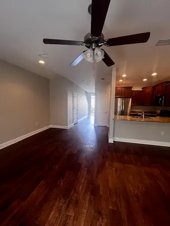 a kitchen with granite countertop wooden cabinets and stainless steel appliances