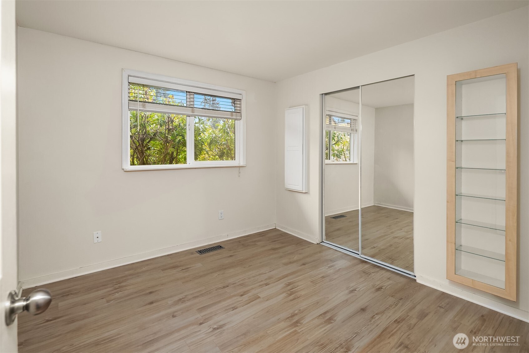 19814 10th Drive Southeast Bothell, WA 98012 - Photo 19 of 40 an empty room with wooden floor closet and windows