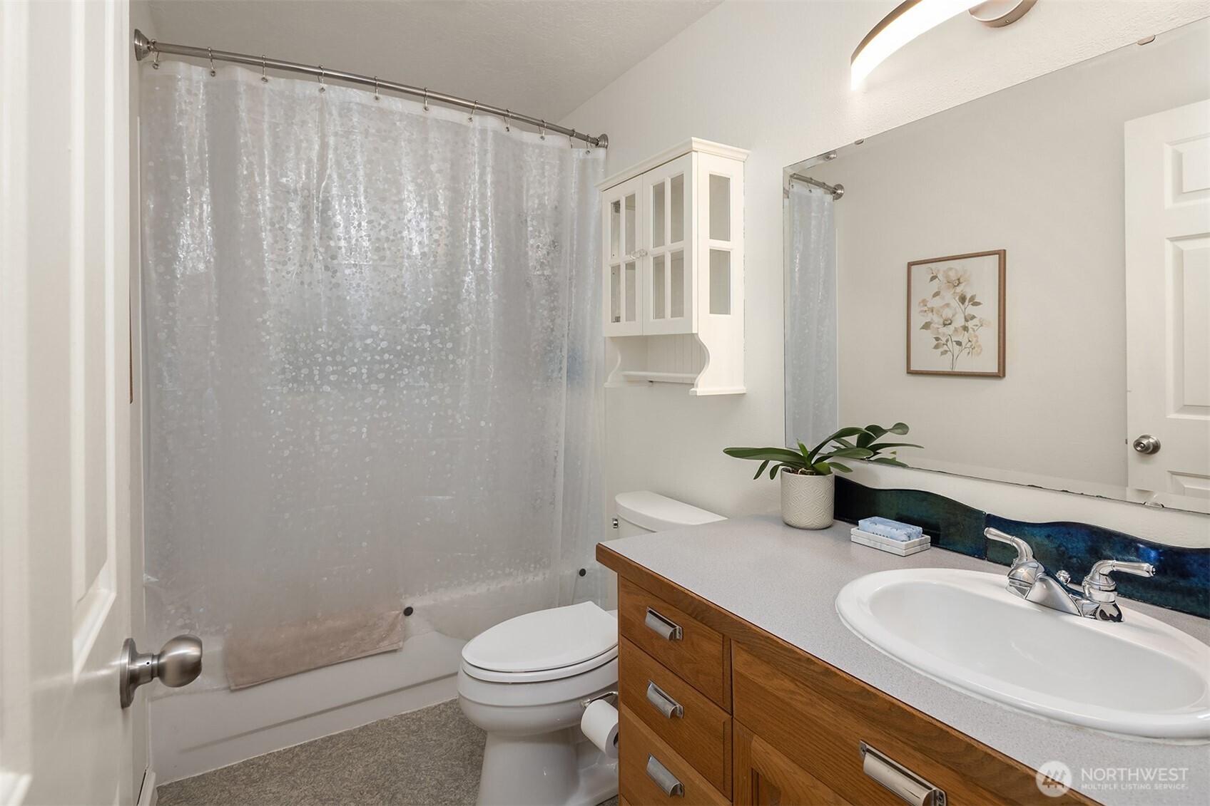 19814 10th Drive Southeast Bothell, WA 98012 - Photo 20 of 40 a bathroom with a sink toilet and shower