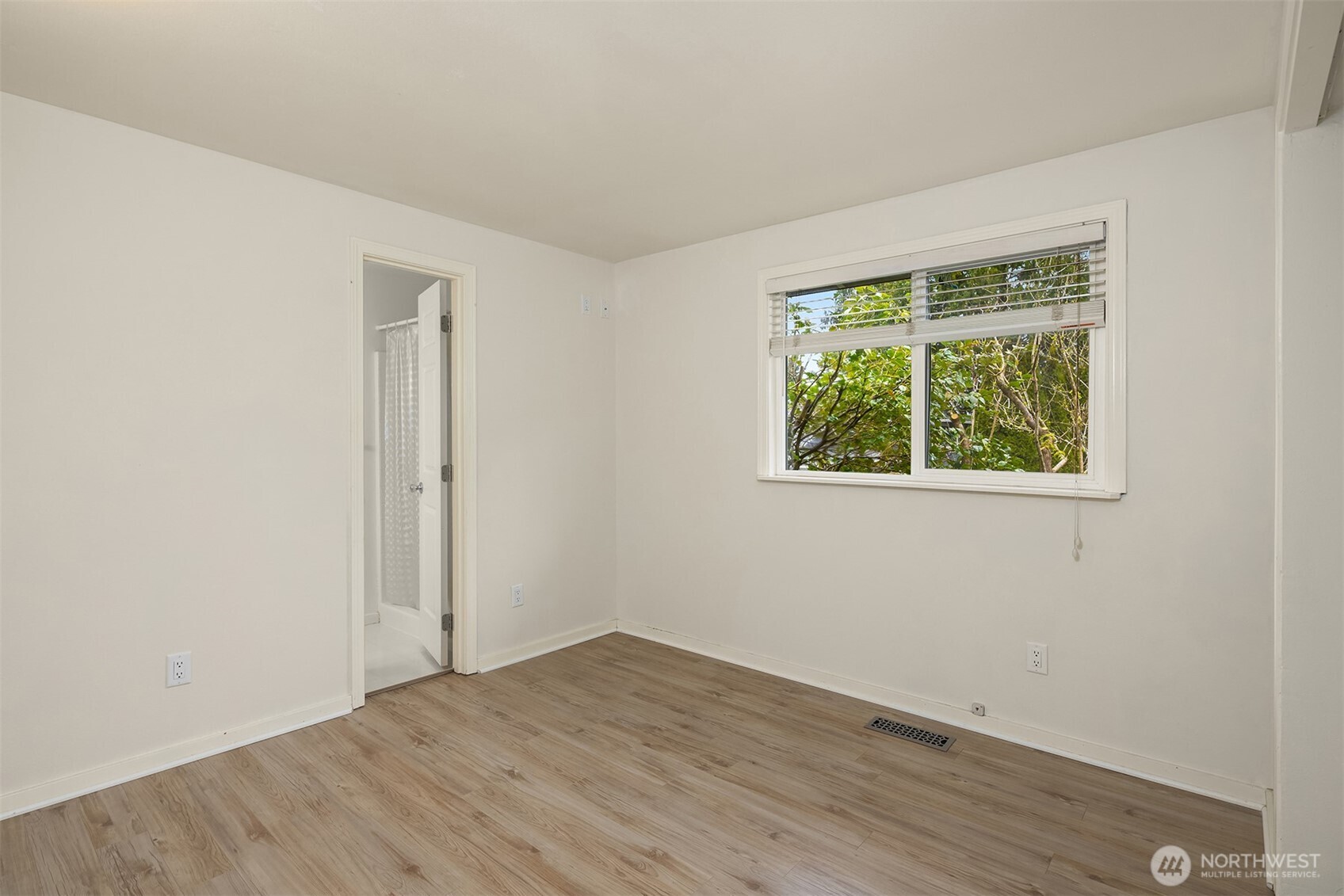 19814 10th Drive Southeast Bothell, WA 98012 - Photo 22 of 40 an empty room with wooden floor and windows