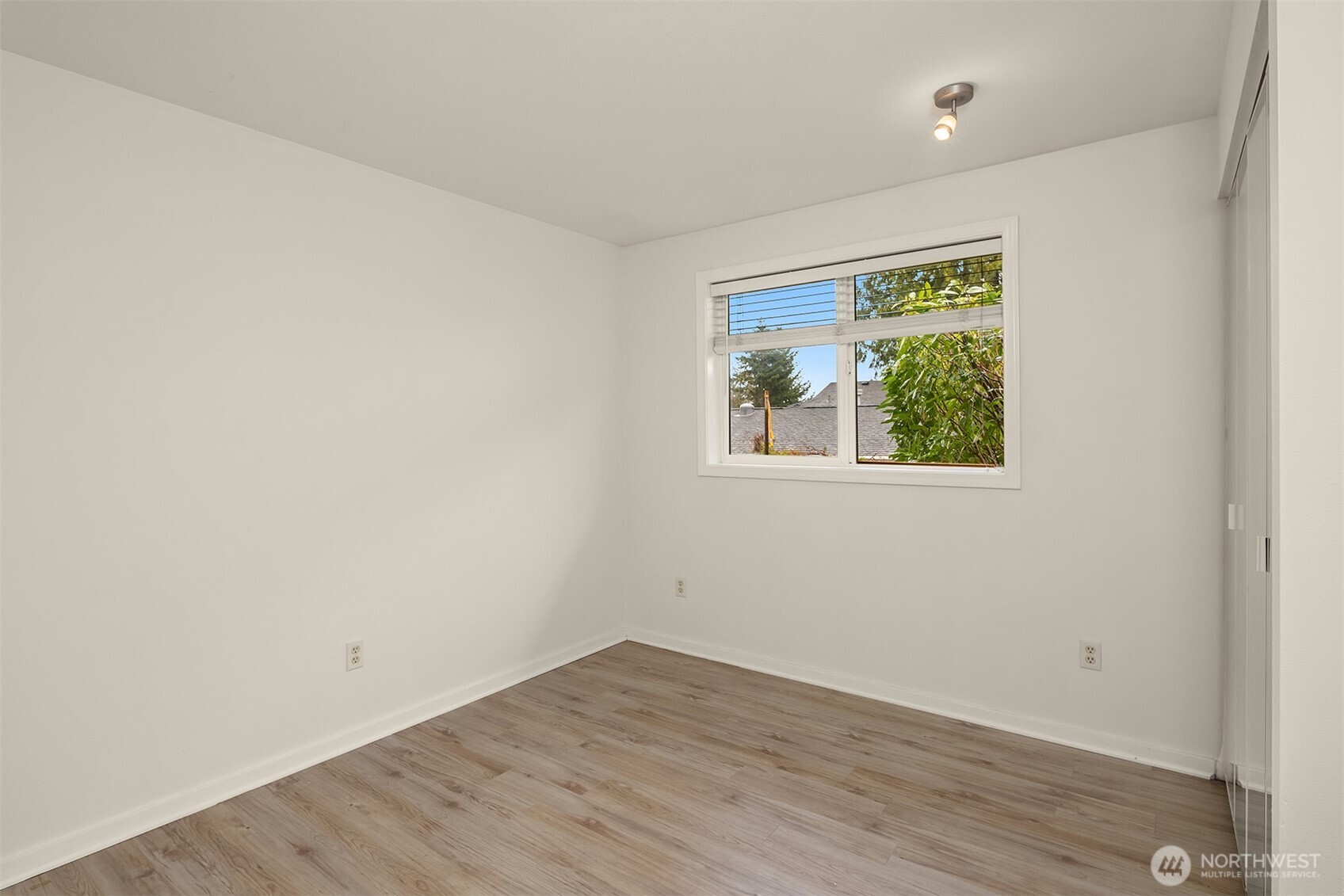 19814 10th Drive Southeast Bothell, WA 98012 - Photo 25 of 40 a view of an empty room with wooden floor and a window