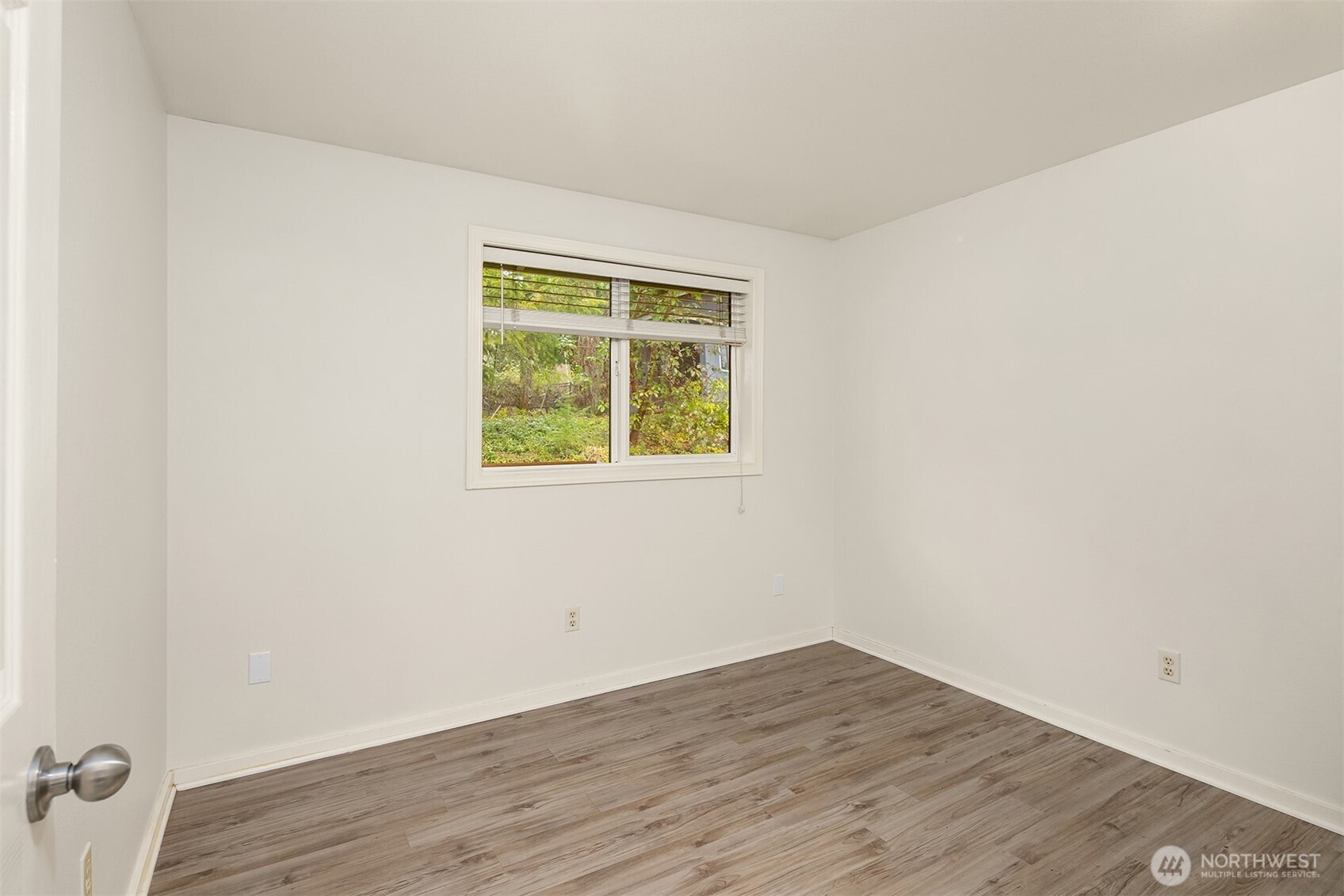 19814 10th Drive Southeast Bothell, WA 98012 - Photo 27 of 40 a view of an empty room with wooden floor and a window