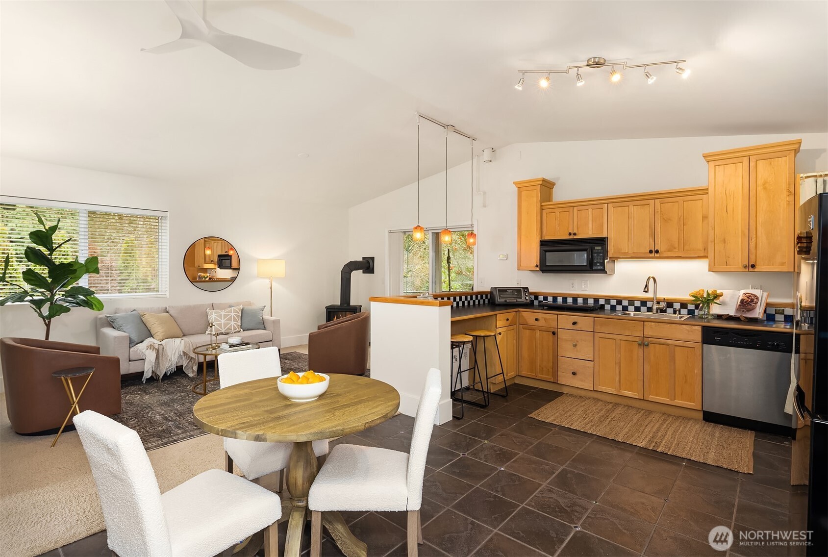 19814 10th Drive Southeast Bothell, WA 98012 - Photo 30 of 40 a kitchen with stainless steel appliances a sink a stove a table and chairs