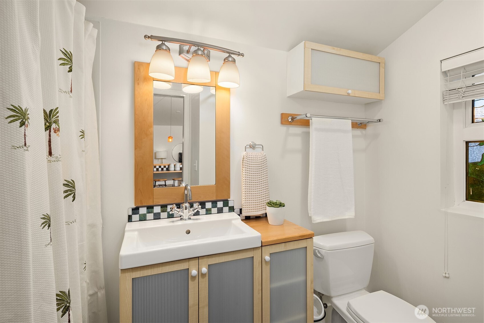 19814 10th Drive Southeast Bothell, WA 98012 - Photo 34 of 40 a bathroom with a sink and mirror with toilet