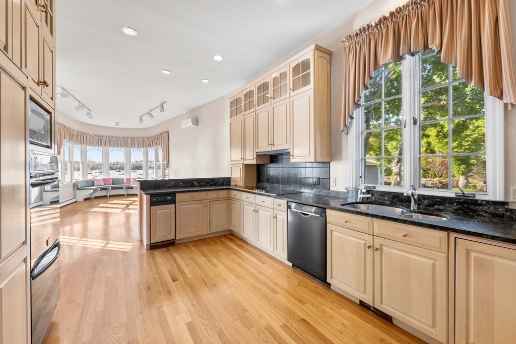 2 Foster Street Marblehead, MA 01945 - Photo 13 of 42 a large kitchen with granite countertop a large window and white appliances