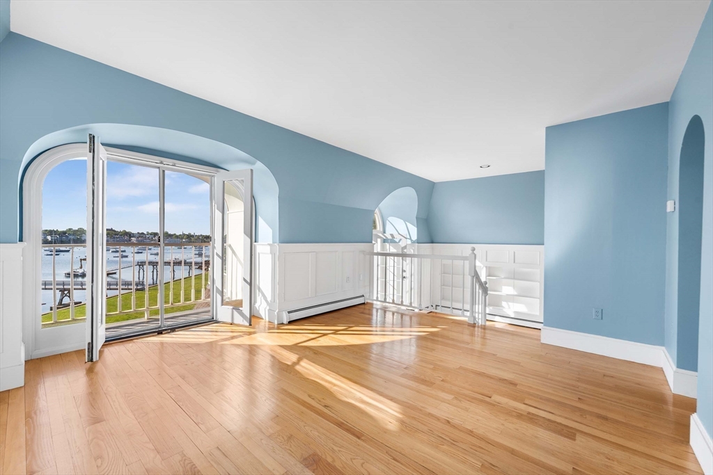 2 Foster Street Marblehead, MA 01945 - Photo 16 of 42 a view of an empty room with wooden floor and a window