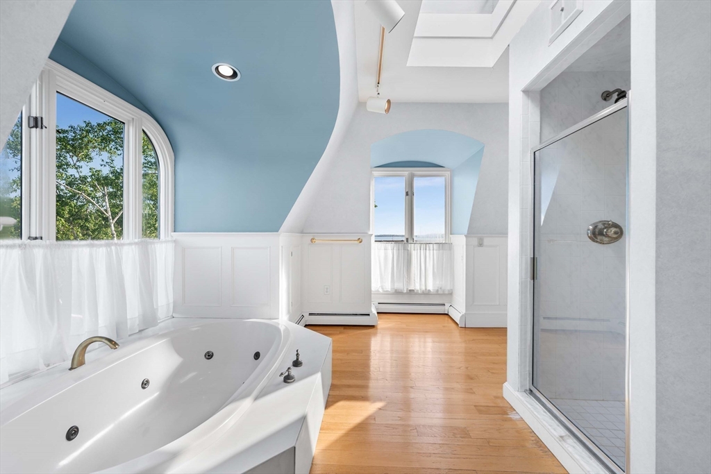2 Foster Street Marblehead, MA 01945 - Photo 17 of 42 a bathroom with a tub a sink and a large mirror