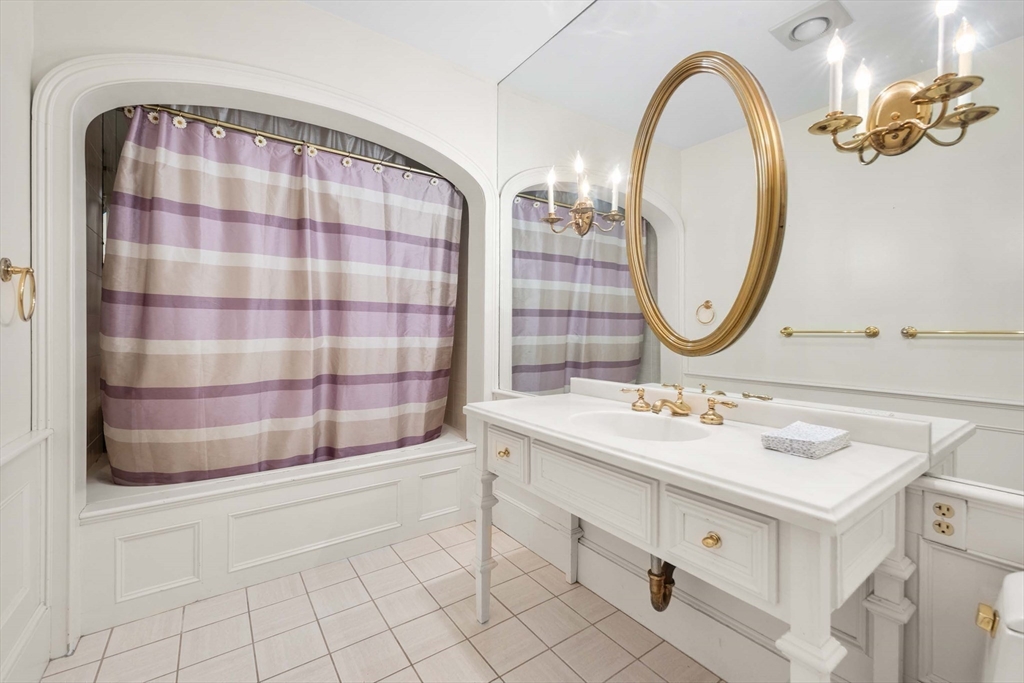 2 Foster Street Marblehead, MA 01945 - Photo 25 of 42 a bathroom with a sink a mirror a vanity and a shower