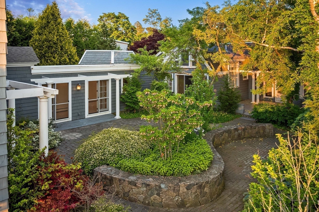 2 Foster Street Marblehead, MA 01945 - Photo 28 of 42 a view of a white house next to a yard with flower plants